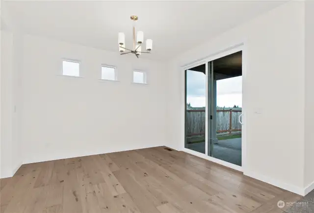 Dining area sliding glass doors lead to covered back porch. Photo for illustration only of similar home, not actual.