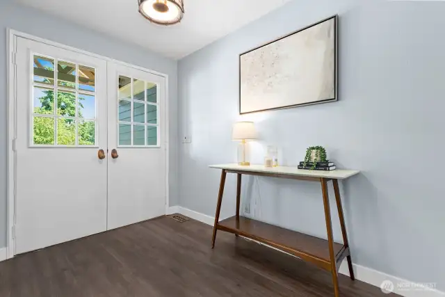Double door entry with luxury vinyl plank flooring