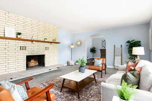 Formal living room with an arch entrance to formal dining room.