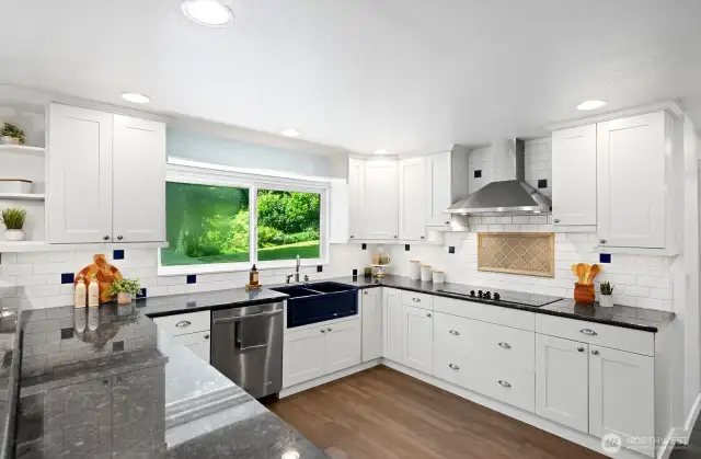 Custom kitchen includes Whitehaus double apron sink, striking granite countertops and custom tile backsplash