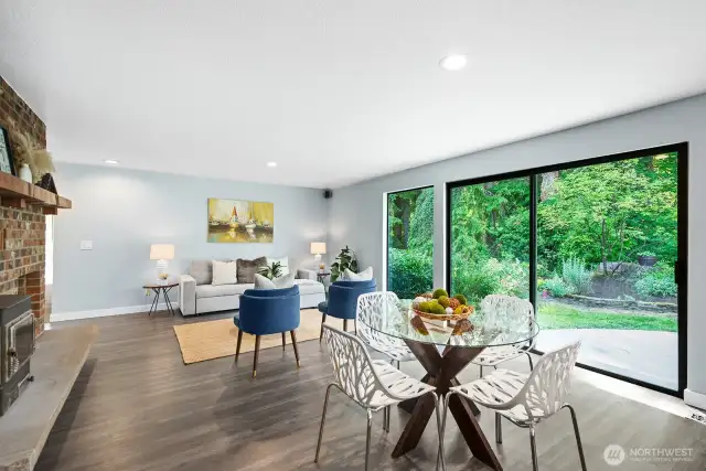 Casual dining area and family room with generous sliding glass door, bringing nature in...