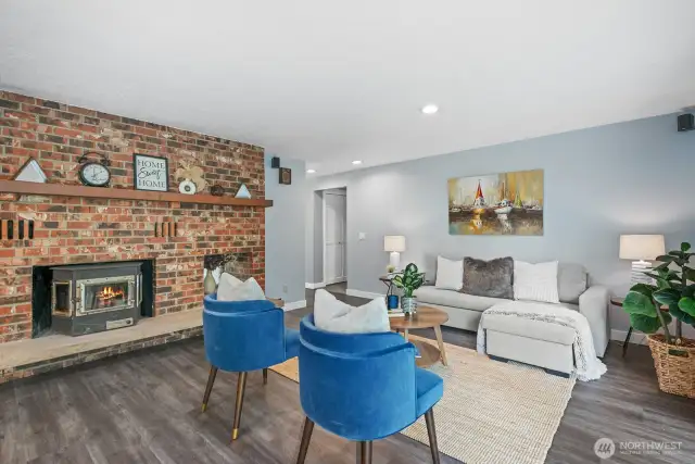Fabulous family room with stunning brick wall and cozy wood burning stove.