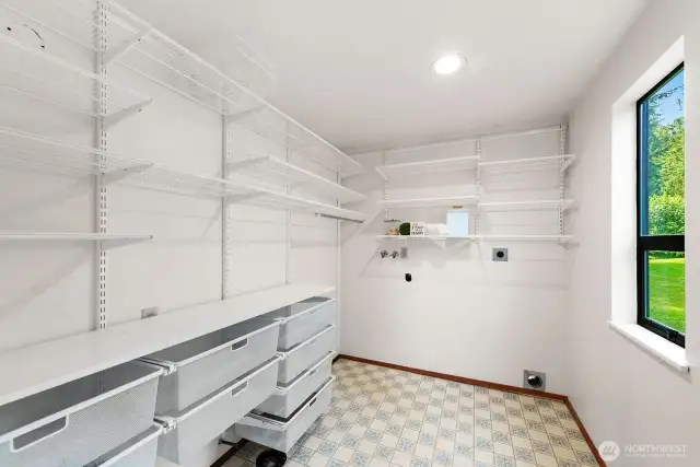 Pantry and laundry room designed with shelving & pull out storage.