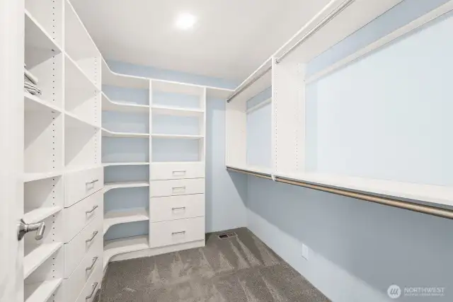 Primary suite closet with built-ins.