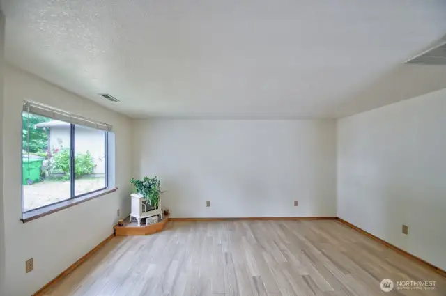 Living room with vaulted ceiling and plenty of natural light.