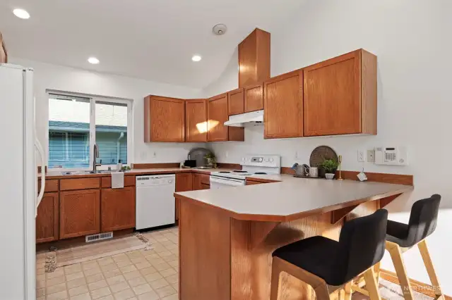 Classic Kitchen with Room to Personalize: Cook, create, and make memories in a bright kitchen with plenty of counter space, solid wood cabinets, and a window overlooking the yard—because the heart of the home should feel like home.