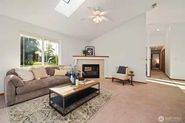 With vaulted ceilings and a skylight to let in the natural lighting, and the cozy fireplace, this room will quickly become one of your favorites.