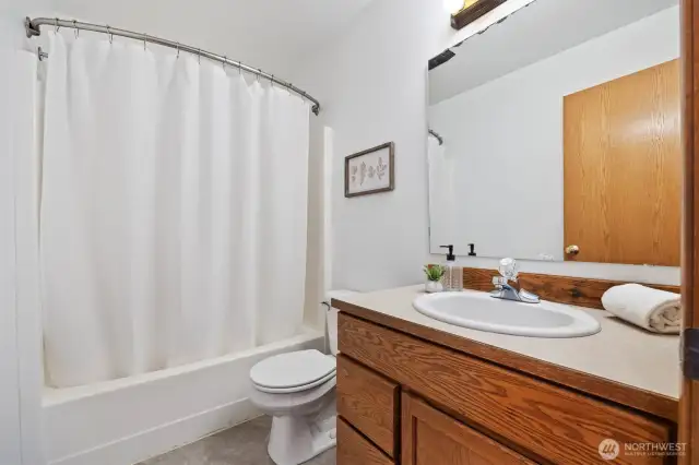 The middle, full bathroom.