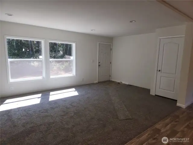Front entry to the living room with useful closet space for storing items.