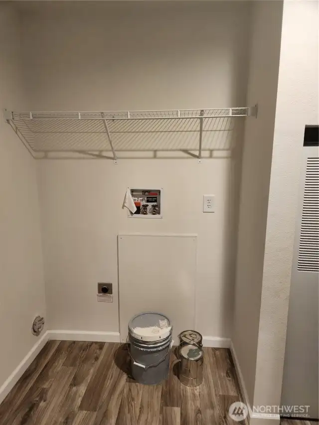 Plenty of room for a side by side washer and dryer, with space above to store laundry detergent and cleaning items.