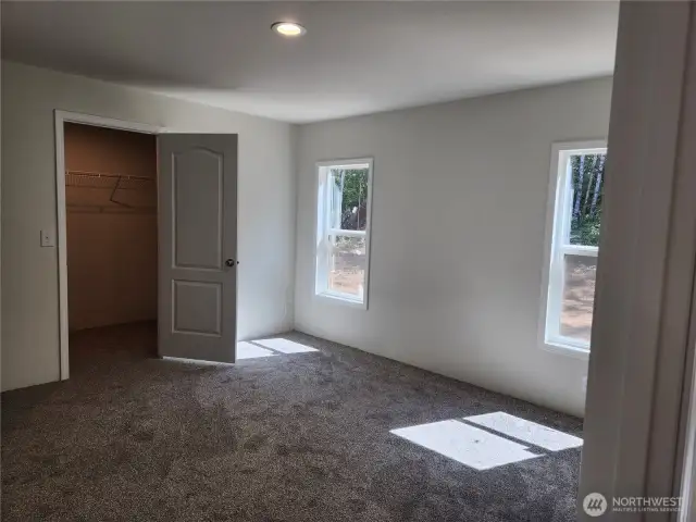 Spacious primary bedroom with a good sized walk-in closet.
