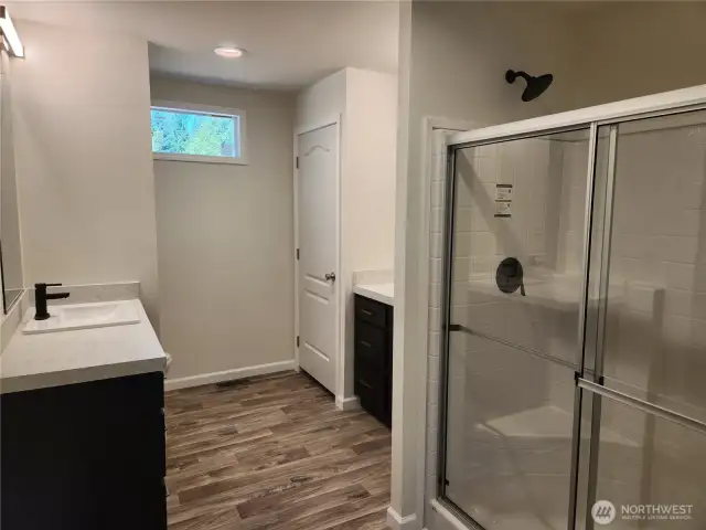 Large ensuite to the primary with his/her sinks and walk-in shower w/seat.