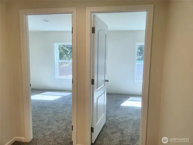 The other end of the home has 2 bedrooms and across the hallway is one more room you can use as bedroom or den/office.