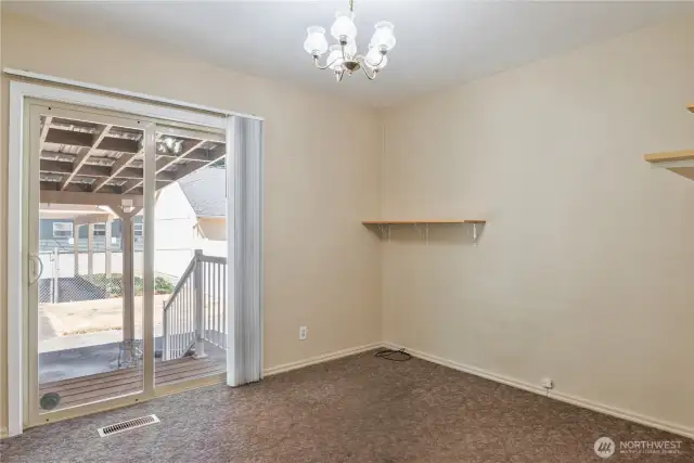 Second bedroom on main floor with second sliding glass door to the backyard