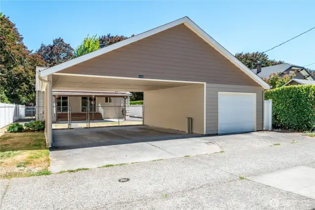 Single car garage with tons of attic storage and 2 car covered carport.
