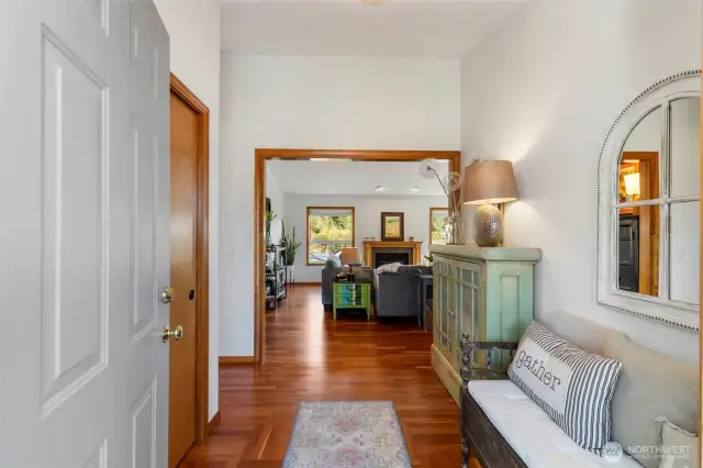 Entry with newly refinished hardwoods throughout the living spaces.