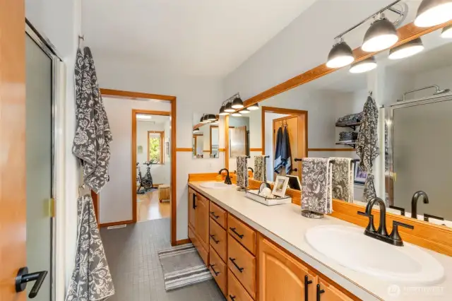 Galley style primary bathroom with addition of studio for fitness or office.