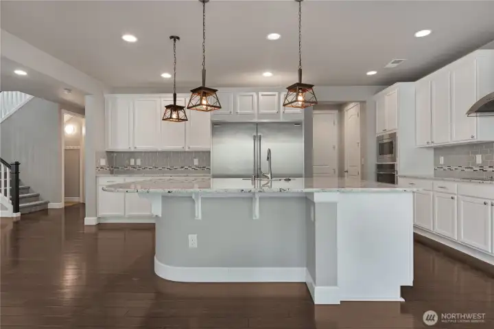 Enormous kitchen with industrial refridgerator.