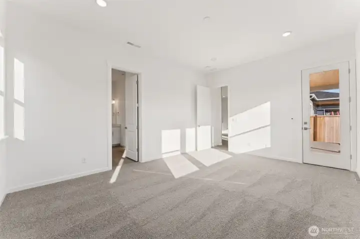 Actual Home   Primary Bedroom with door leading to covered patio