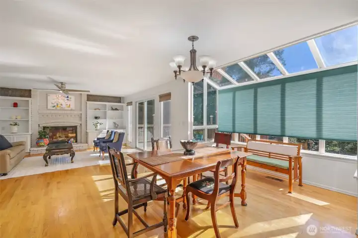 The adjoining casual dining space is filled with natural light from skylight windows and walls of glass. Overlooking the backyard and connected to the family room, this bright setting makes every meal feel relaxed and connected to nature.