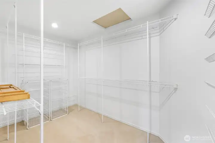 A spacious walk-in closet offers extensive shelving and storage, ensuring room for wardrobe organization and seasonal needs with ease.