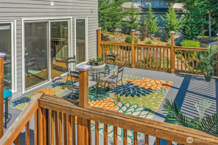 Another angle of the deck highlights its connection to the home’s main living areas through sliding glass doors, making indoor-outdoor entertaining effortless.
