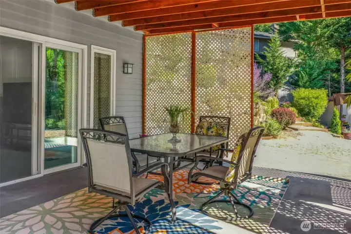 The covered patio below provides a shaded outdoor retreat that is usable year-round. With easy access to the landscaped yard, it’s perfect for casual gatherings.