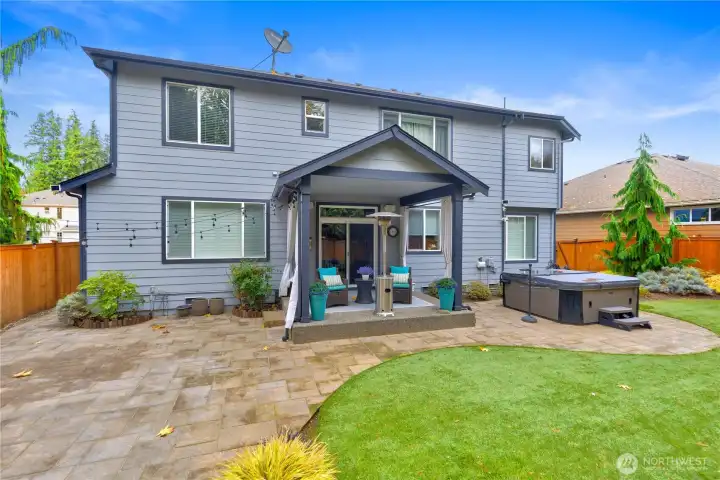 ...another view showing off the covered patio, hot tub (stays) and beautiful pavers.