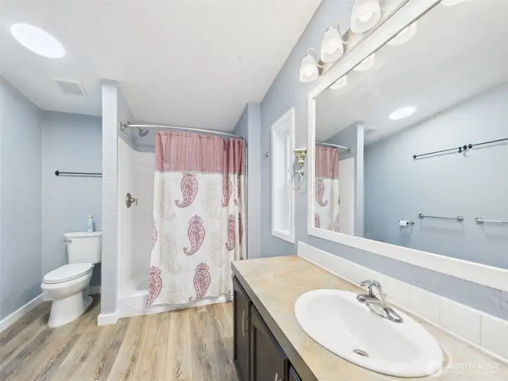 Walk-in shower in primary room.