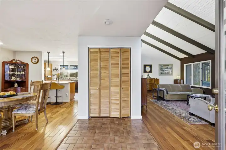 Entryway with tiled floor. Large living room on the right and dining room on the left. The kitchen is beyond.