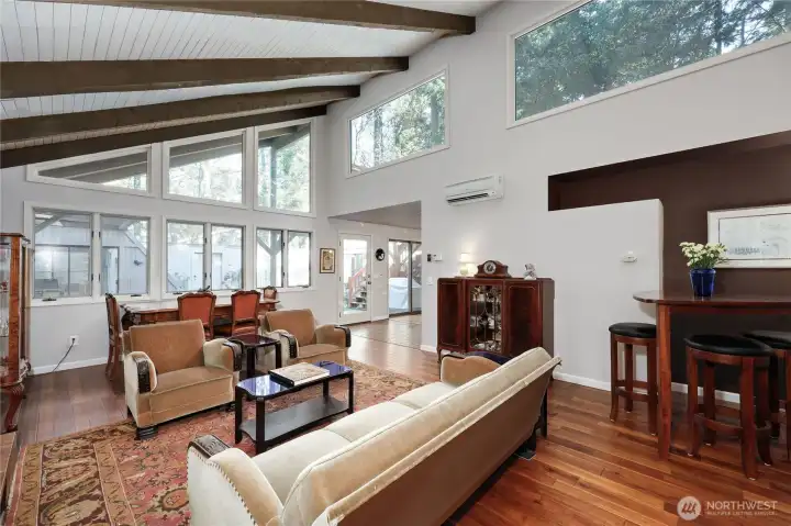 Look out from the living room to the sunny courtyard. Many large windows bring light in. Mini-split delivers heat and AC.