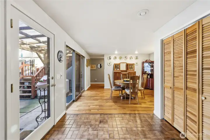 Looking from the living room past the front door on the left and the double closet. This closet is two closets deep; the second closet has the crawl space access.