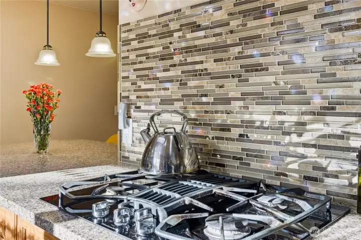 Gas cooktop with downdraft venting.