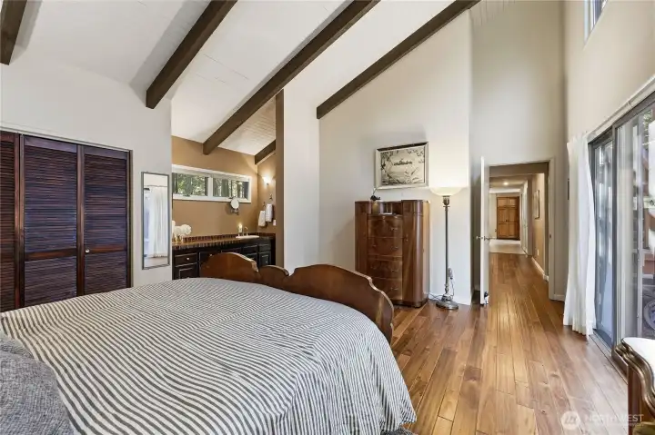 The primary bedroom also has the sink and vanity. Here you can see down the hall towards the kitchen.