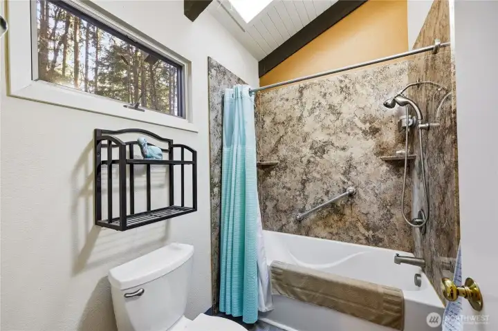 Deep tub, skylight and adjustable shower fitting make this a useful bathroom.