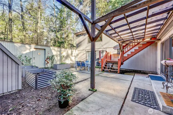 This large courtyard is great for BBQs, gatherings, and growing food. The stairs lead up to the flat roof area and more storage.