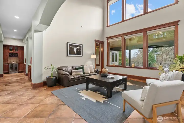 Sitting area with soaring ceilings that bring in natural light.