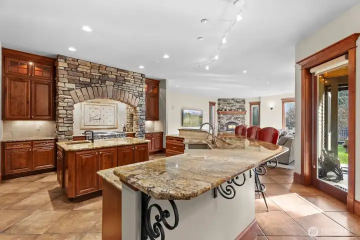 Chef's kitchen has upgraded dishwasher, trash compactor, two sinks , commercial gas range.