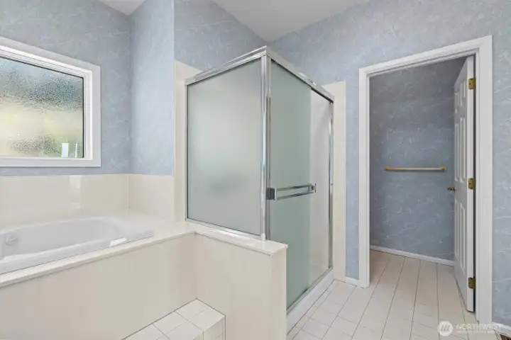 Primary bathroom with walk-in closet (staged)