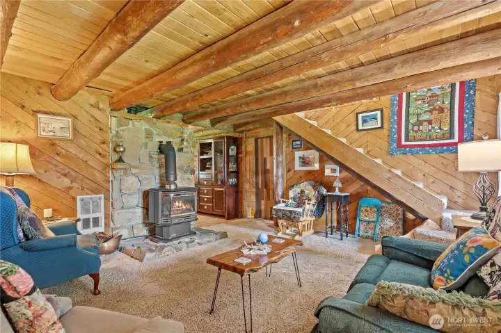 View from the Front Door: Stone Surround Gas Fireplace, Staircase leads to Bedrooms, Doorway leads to Bathroom.
