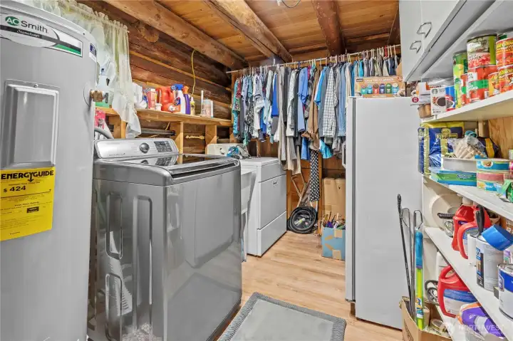 Off the Dining Room you'll find this Mud Room / Laundry Room. This room offers extra space for the additional fridge plus room to dry clothes. The newer Electric Hot Water Heater in here too. All appliances stay!