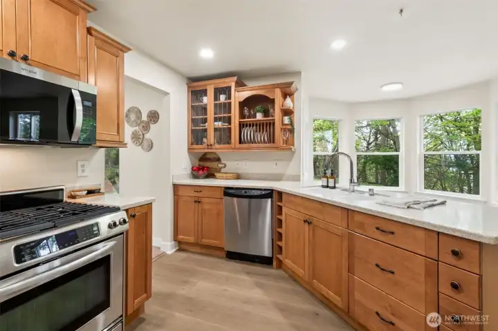 This beautifully designed kitchen features rich maple cabinetry paired with custom wine and dish storage that adds both style and function. Thoughtfully crafted built-ins keep your favorite bottles and serveware on display, creating a space that feels curated and inviting.