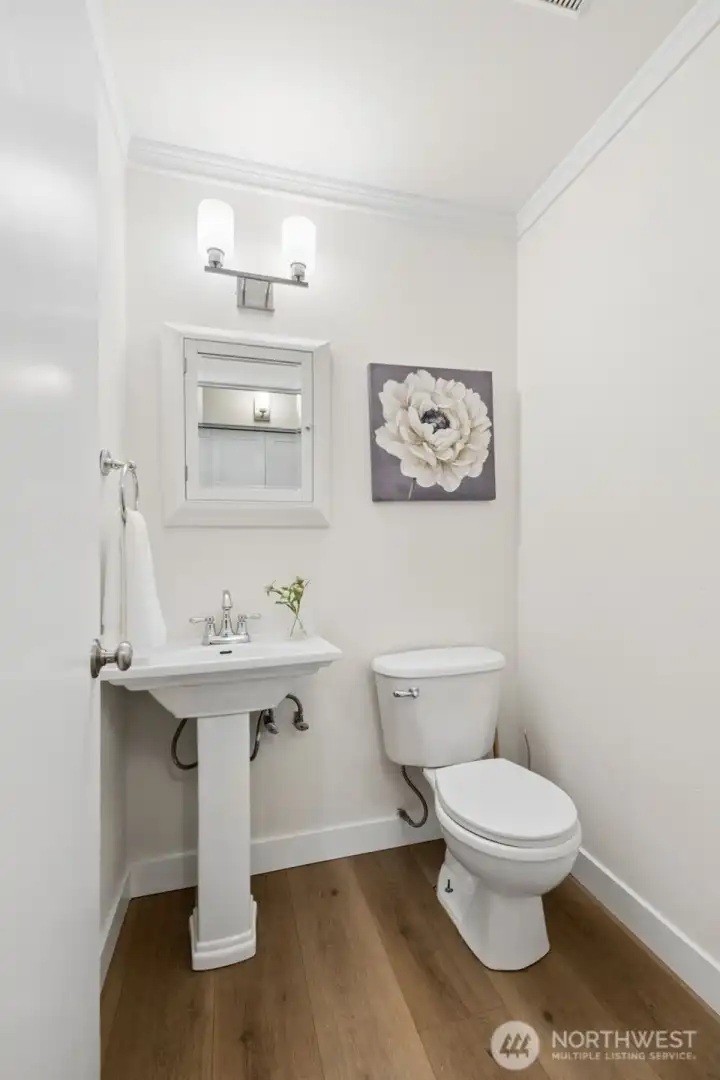 A convenient half bath on the main floor has been tastefully updated. It adds both style and functionality to the home’s layout.