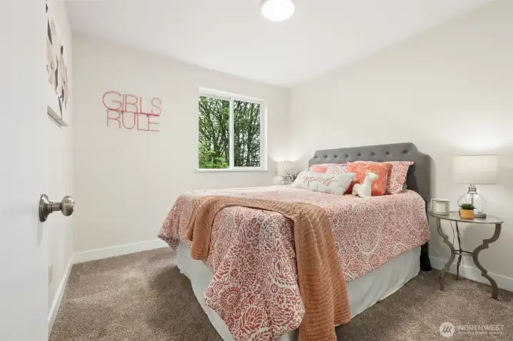 The second bedroom features fresh paint and new carpet, creating a bright and comfortable space. It’s perfect for family, guests, or a personal retreat. It overlooks the beautiful back yard and forest.