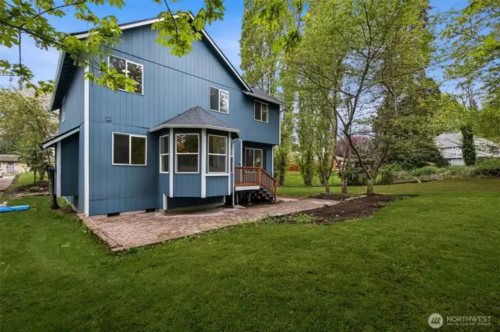 The open lawn area offers plenty of room for outdoor activities, from summer gatherings to quiet relaxation. It’s a blank canvas for your outdoor vision. (New grass just springing up to right of photo!)