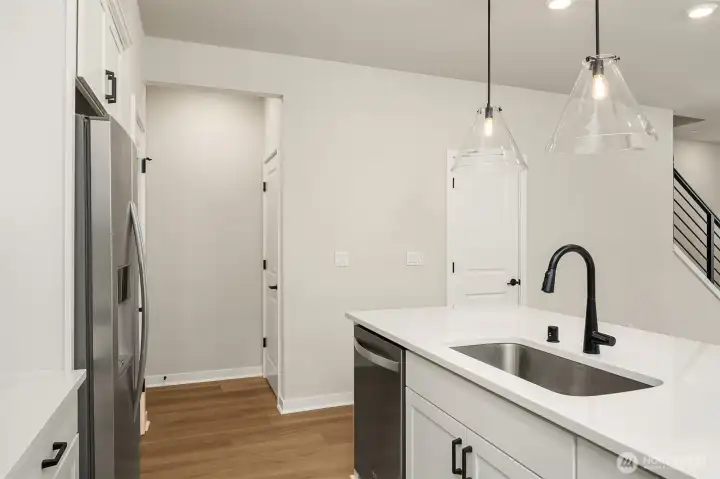 Hallway to garage and door to powder room