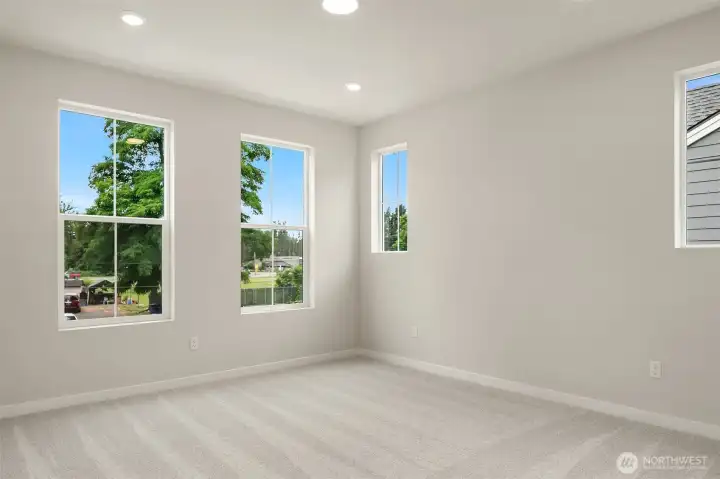 Primary bedroom nicely accommodates king-sized furniture
