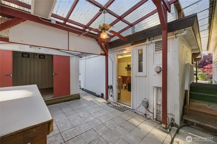 Enclosed patio has access to both sheds