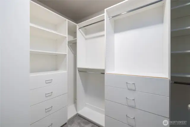 Primary walk-in closet with custom built-in storage