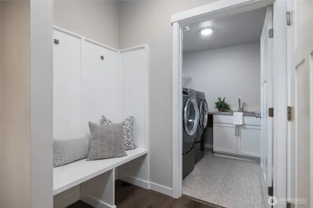 Built-in bench off the garage entry and excellent laundry room with storage and sink